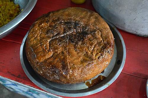 A round of chhena poda with a caramelised crust